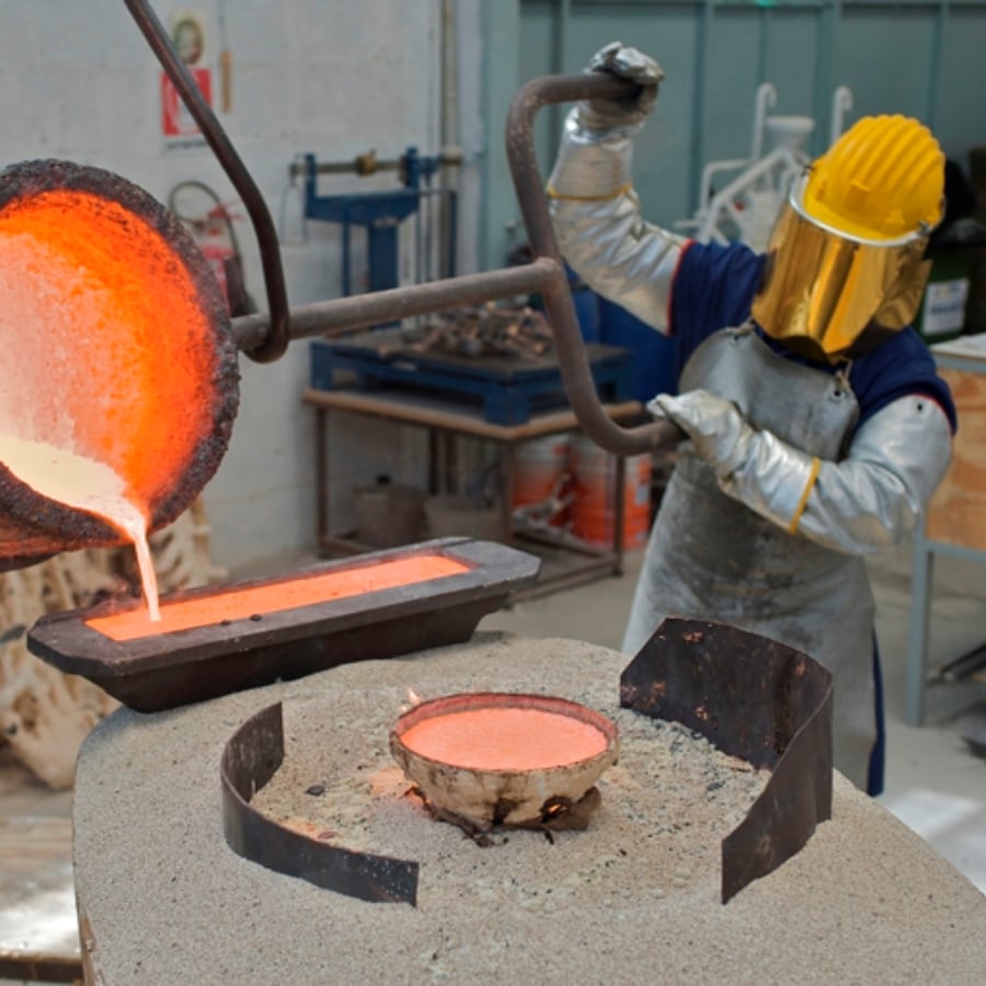 metalworker making iron bars